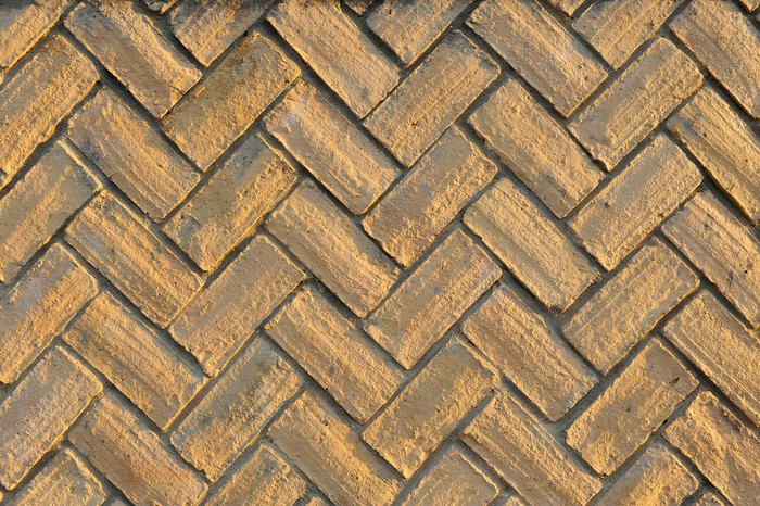 Vinilo Pixerstick Ladrillos colocados en espiga, pavimento, zócalo